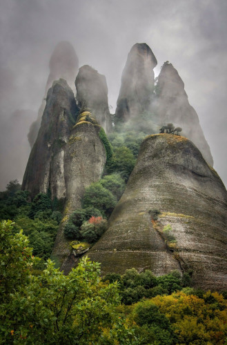 Breathtaking rock pinnacles reaching into the clouds rising up from the Thessalian plain of Greece. Known as Meteora. 