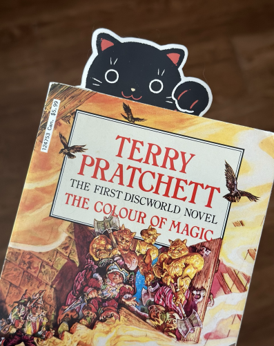 The Colour of Magic, the very first #Discworld novel, with a charming Geri Coady Japanese lucky cat sticker as a bookmark. 