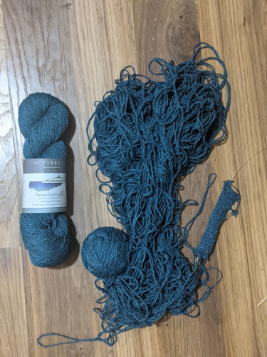 A nice hank of yarn, next to a giant, tangled mess of yarn barf.