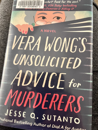 Library book. Can’t make out cover blurb due to barcode. Image of woman with glasses down on her nose and puffy gray hair peering through miniblinds. Text says “A NOVEL VERA WONG’S UNSOLICITED ADVICE for MURDERERS Jesse Q. Sutano National Bestselling Author of Dial A for Aunties”