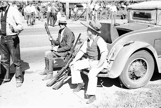 This is a photograph of agricultural growers and law enforcement during the Salinas Lettuce Strike of 1936. Salinas Lettuce Strike. 1936. Otto Hagel. Gelatin silver print. Collection of Oakland Museum of California. Gift of Paul S. Taylor.