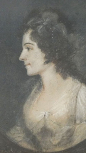 A portrait of Elizabeth Schuyler Hamilton in 1795, by James Sharples. She is in profile, looking intently to the viewer's left. She has her hair curly and somewhat dressed up with pearls and feathers or ribbons. She wears a gauzy white dress.