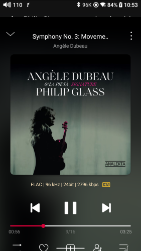 Screenshot from HiRes audio player with album cover. It is Angèle Dubeau in the center, mostly in shadows, holding a violin that is shaded back and red. The background looks like of the long, large, tie-dye sheets that people hang over their windows or on their walls, but this one is only two colors, white and a light blue.  