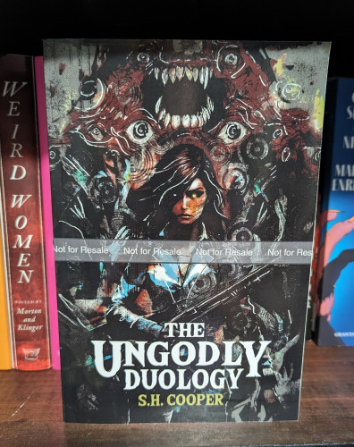 Cover of THE UNGODLY DUOLOGY. A woman stands fearlessly with a shotgun in front of an eldritch monster