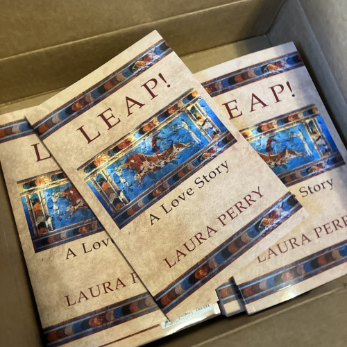 A cardboard box full of paperback copies of my Minoan historical novel Leap! A Love Story.