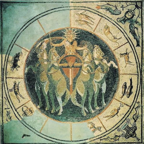 Central panel of a floor mosaic showing the god Sol Invictus riding a quadriga and wearing a radiate crown. Around him in a circular border are the twelve signs of the zodiac. Some are missing but most are visible.