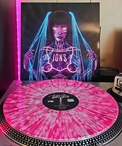 A Pink w/ White Splatter vinyl record sits on a turntable. Behind the turntable, a vinyl album outer sleeve is displayed. The front cover shows a naked android lit up with neon lights