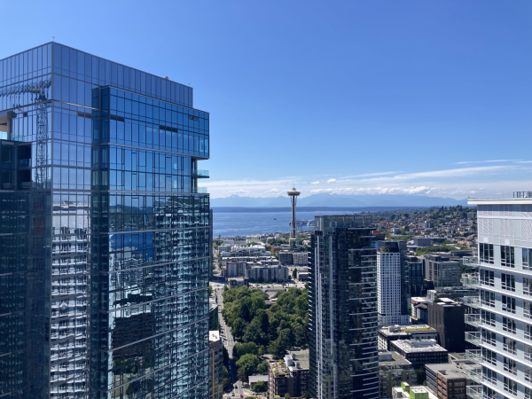 Seattle skyline, seen from the observation deck of a tall building, with the Space Needle in the midground center. 