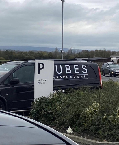 Van for some business with “ubes” in the name parked behind a “P” parking sign…I think you can figure it out from there.