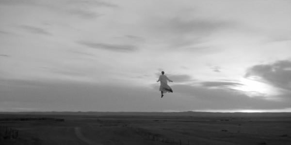 screen shot from El Conde
Carmen, the nun, enjoys flight over barren plains and under cloudy sky, as a new vampire. 