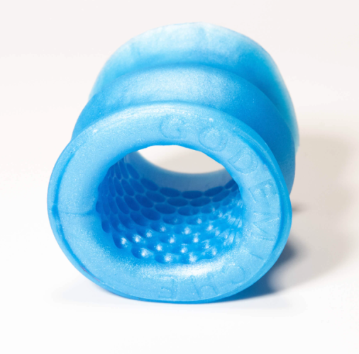 Image of a blue silicone cock sleeve with tiny recessed dents inside to provide texture