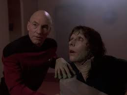 Troi in a tub turning into a fish with Picard kneeling next to her