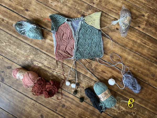 In-progress knitting project update with the ten "live" color skeins hanging loose