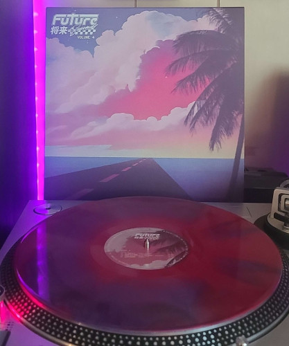 A Purple & Red Swirl vinyl record sits on a turntable. Behind the turntable, a vinyl album outer sleeve is displayed. A road with water on each side, and a palm tree to the right. The sky is filled with large clouds