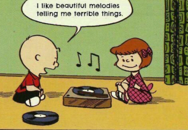 Panel from Charlie Brown comic strip. Charlie and another character are sitting on the floor listening to a portable record player. Charlie is saying: "I like beautiful melodies telling me terrible things."