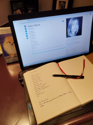Handwritten transcription of the poem "Injury Room" by Katie Ford sits on a computer keyboard, with the poem displayed on the computer screen on an Academy of American Poets web page, including a picture of the poet. An uncapped black pen and a red bookmark ribbon rests on the notebook page.