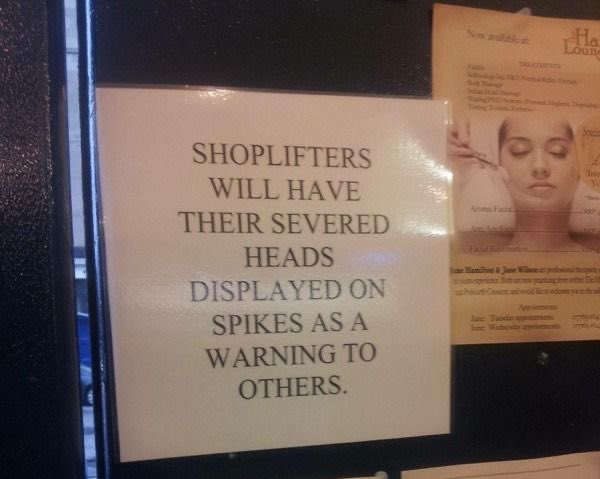 Photo of a hand produced notice in a shop window reads
Shoplifters will have their severed heads displayed on spikes as a warning to others