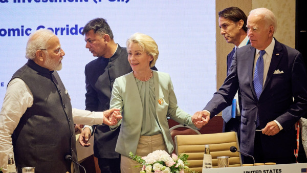 A photo with India's PM Narendra Modi, European Commission President Ursula von der Leyen, and US President Joe Biden holding hands. 