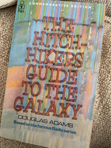 Front cover of a copy of The Hitchhikers Guide to the Galaxy