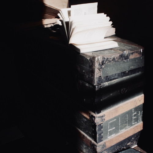 An open book on top of an old trunk.