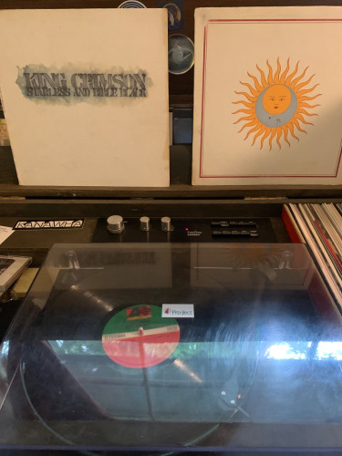 Two King Crimson albums sit on the stereo ready to play -  lark’s tongues on the turntable 