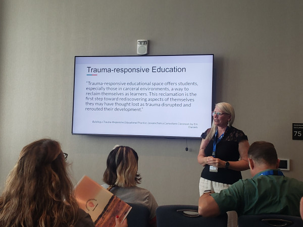 Photo of a slide that has a passage from my book quoted.  Passage (paraphrased) is "trauma-responsive educational spaces offer students a way to reclaim themselves as learners.  This reclamation is a first step toward rediscovering aspects of themselves they may have thought lost as trauma disrupted and rerouted their development." (Daniels, 2022)
