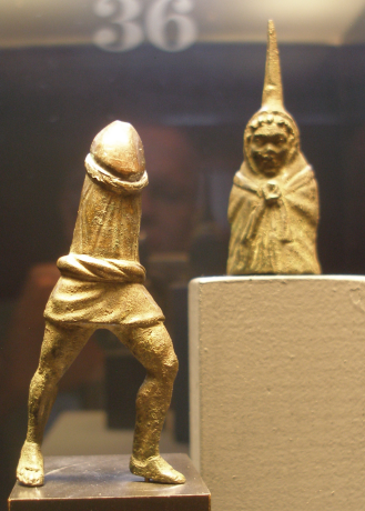 A Roman Priapus figurine of a hooded Priapus wearing a cloak and a very short tunic. The top part canbe taken off to reveal a phallus so it is a phallus on legs.