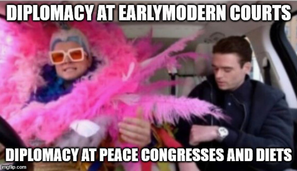 Two persons: the one on the left wears a huge pink feather boa and looks at the viewer, the one on the right is dressed in a black jacket and lowers his gaze.
At the top of the picture is written: Diplomacy at earlymodern courts
At its bottom: Diplomacy at peace congresses and diets.