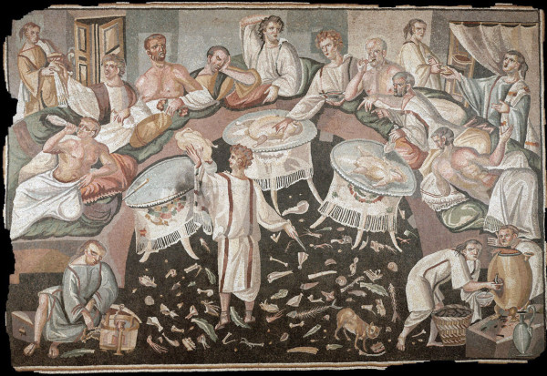 A large mosaic scene showing nine diners eating, drinking, and apparently throwing scraps on the floor of the triclinium. Seven slaves appear to be facilitating service of food and drinks.