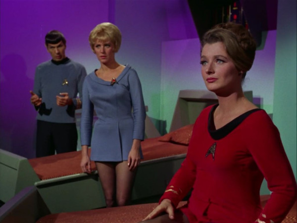 Dr. Ann Mulhall with Spock and nurse Chapel in the background. They are all in sickbay 