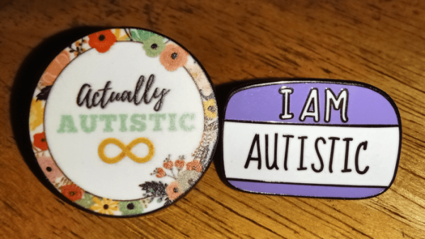 Actually Autistic and I Am Autistic button pins.