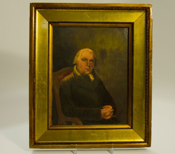 A painted portrait of James Madison, seated, dressed in black, hands folded. The portrait is in a gold frame. 