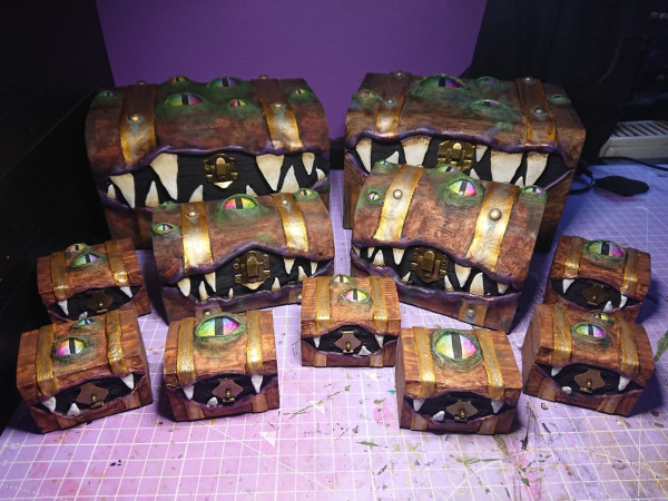 A variety of different size treasure chests with eyes and teeth