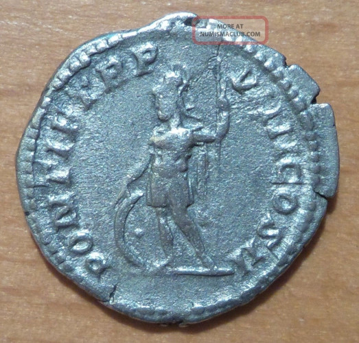Silver coin depicting the Roman god Mars. He is naked save for a helmet and a cloak hanging from his shoulder. His is holding a branch and his spear. A round aspis shield rests by his feet.