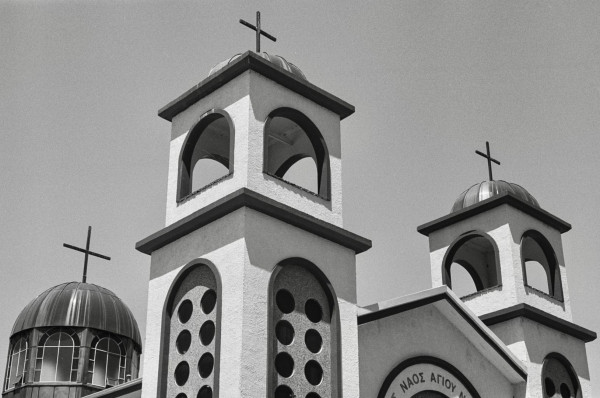 Black and white image of the spires of a Greek Orthodox Church.