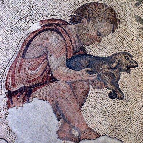 Mosaic with a white background. A you g child dressed in pink and red robes appears to be sitting and holding a puppy.