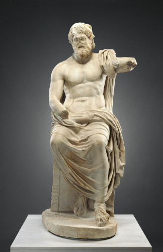 Portrayed as a mature bearded man, Zeus sits enthroned in his role as king of the gods. Originally he would have held his attributes: a scepter and a thunderbolt. The colossal god towers over his mortal observers.