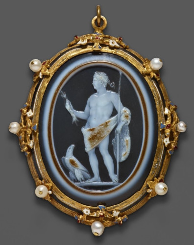 Description from museum: “This intricate cameo is carved from a piece of sardonyx, a mineral composed of parallel colored bands. The figure at the center is depicted with the portrait head of an emperor from the Julio-Claudian dynasty (27 BCE–68 CE) and the idealized, partially nude body of the supreme deity Jupiter (the Greek god Zeus). Created for circulation among members of the imperial court, the cameo boldly equated the ruler’s power over the Roman Empire to that of Jupiter over the entire cosmos.”