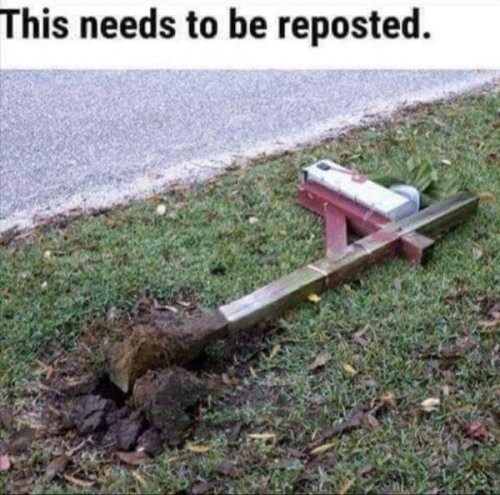 A picture of a postbox on the ground with the text "This needs to be reposted."