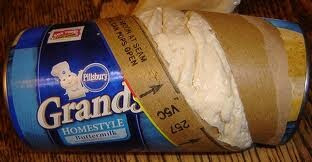 Can of Pillsbury Grands biscuits popped open with the dough exploding out