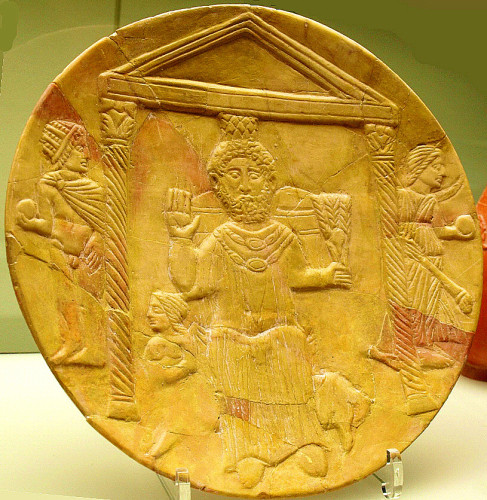 Baal-Saturnus, enthroned, with sun god Helios-Sol on his left, wearing a sunray crown and holding a globe. His sister, moon goddess Selene-Luna is depicted on the right.