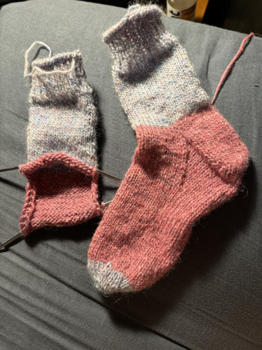 Left, sock in progress, cuff and leg in light blue, heel flap in pink. Right, completed sock, cuff and leg in light blue, heel/foot in pink, toe in light blue