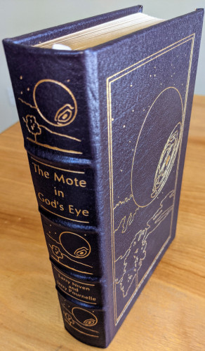"The Mote in God's Eye" by Larry Niven and Jerry Pournelle - Stunning dark purplish/blue  leather volume with original artwork by Bob Eggleton  - Collector's Edition Accented in 22kt gold, printed on archival paper with gilded edges, smyth sewing & concealed muslin joints - Bound In full leather with hubbed spines - Includes pristine bookplate on inside of front cover