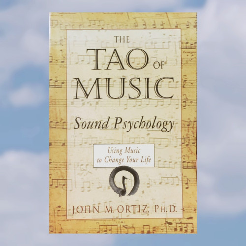 A photo of a book super-imposed on a background photo of blue skies with light clouds.

The book is, "The Tao of Music – Sound Psychology – Using Music to change your life" by John M. Ortiz, Ph.D.

This trade-paperback book of average dimensions has a background cover image of age-yellowed paper sheet music