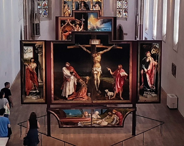 Striking crucifixion painting. The suffering Christ stands out in front of a dark sky. On his right, his mother Mary, in anguish, collapses in the arms of the disciple John, and Mary Magdalene kneels in prayer. On his left, John the Baptist points to Christ