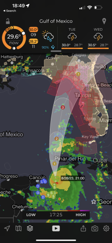 Screenshot of MyRadar app for the Gulf of Mexico showing the current location (southeast of Cancún, México and southwest of Cuba) and predicted track for Tropical Storm Idalia, forecast to grow to a category 3 hurricane before making landfall between Tallahassee and Tampa, Florida.