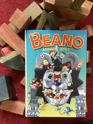 Cover of The Beano Annual 2003 on a pile of wooden blocks