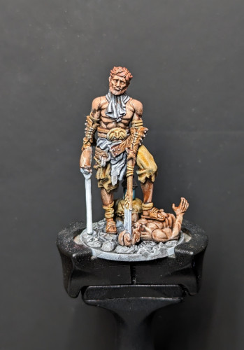 A "boutique nightmare horror" mini from Kingdom Death: Monster. A murderer stabs over his partially dismembered victim, a dull look of nonchalance on his face.