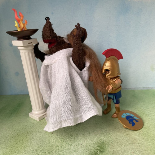 Photo of Minima the Latin mouse as Cassandra, clinging to a column in the temple as a Playmobil Agamemnon pulls her away by the hair