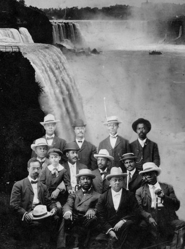 A photo illustration of some of the attendees at the first Niagara Conference posing with the waterfalls in the background. Top row, left to right: H.A. Thompson, New York; Alonzo F. Herndon, Georgia; John Hope, Georgia, (possibly James R.L. Diggs). Second row, left to right: Fred McGhee, Minnesota; Norris B. Herndon;[1] J. Max Barber, Illinois; W.E.B. Du Bois, Atlanta; Robert Bonner, Massachusetts, (bottom row: left to right) Henry L. Baily, Washington, D.C.; Clement G. Morgan, Massachusetts; W.H.H. Hart, Washington, D.C.; and B.S. Smith, Kansas.[2][3] (1905 silver gelatin print.)